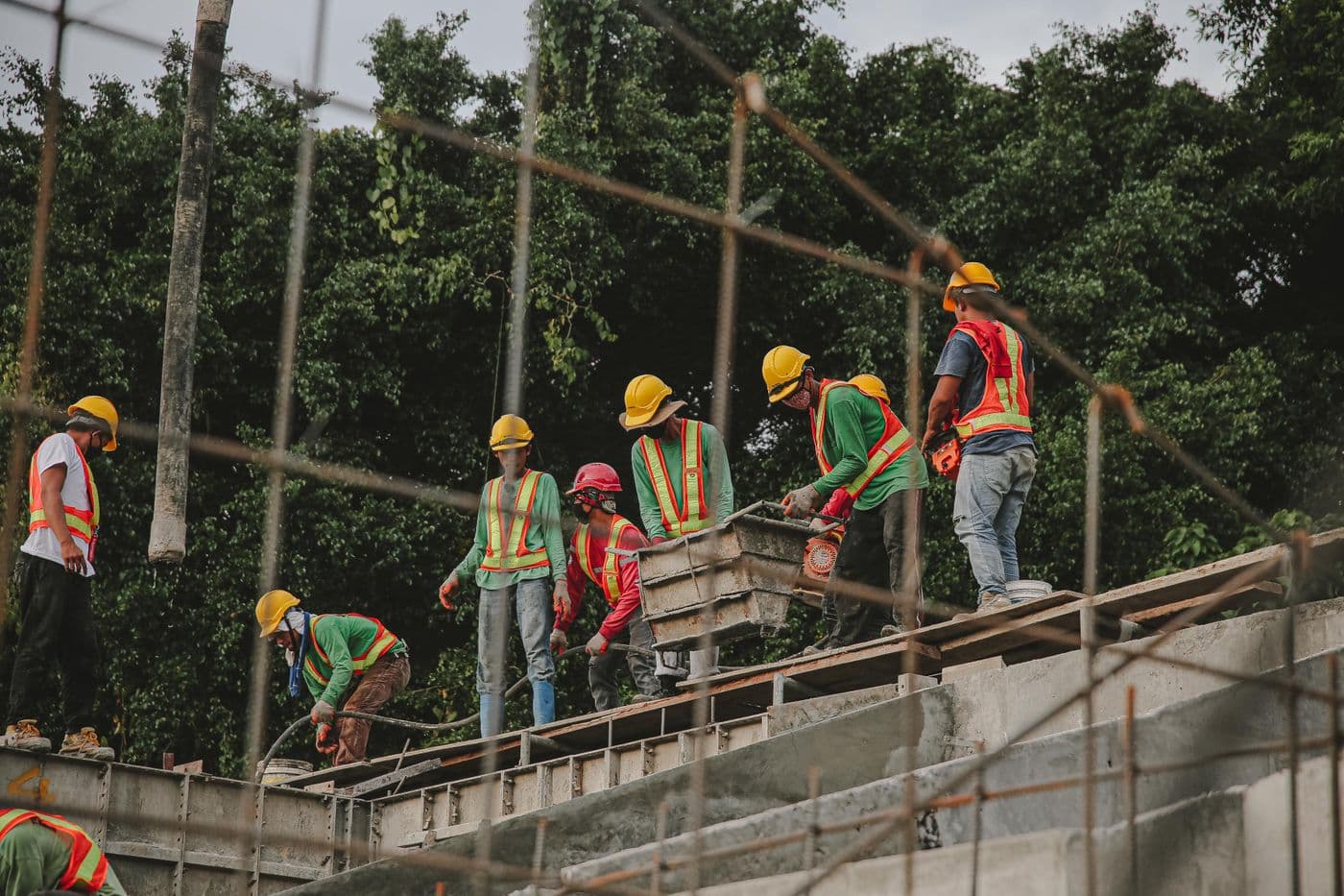 A construction crew heads-down on the build while marketing slips
