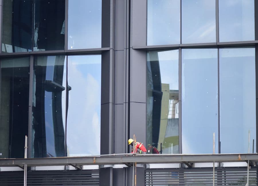 Glazing work on an active construction site