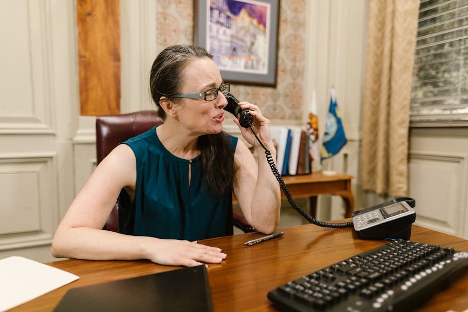 Executive taking a call at an office desk